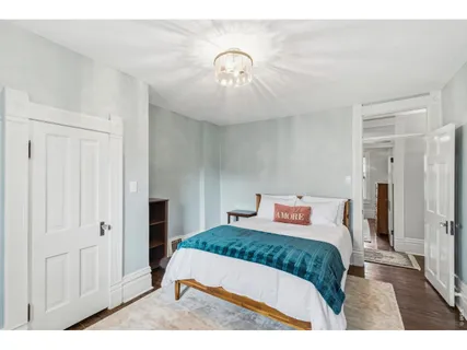 a bedroom with a large bed and a window