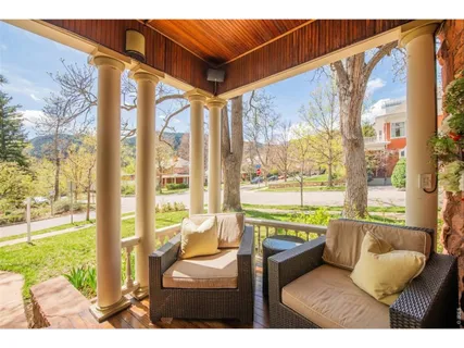 a view of a living room and a floor to ceiling window and wooden floor