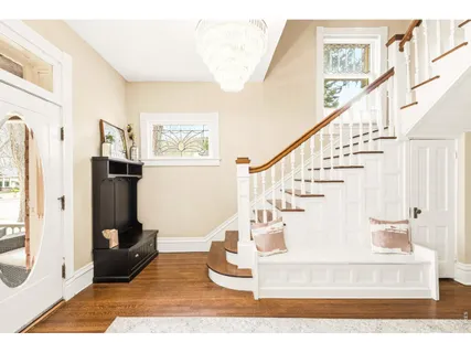 a view of entryway and hall with wooden floor