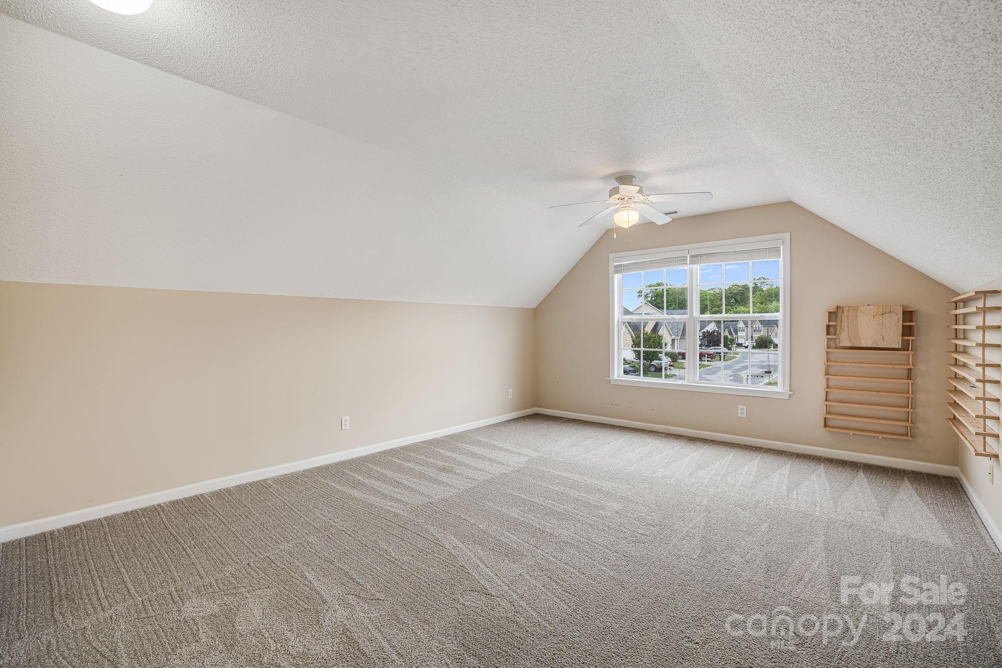 59 Yadkin Road Fletcher, NC 28732 - Photo 16 of 35 an empty room with windows and ceiling fan