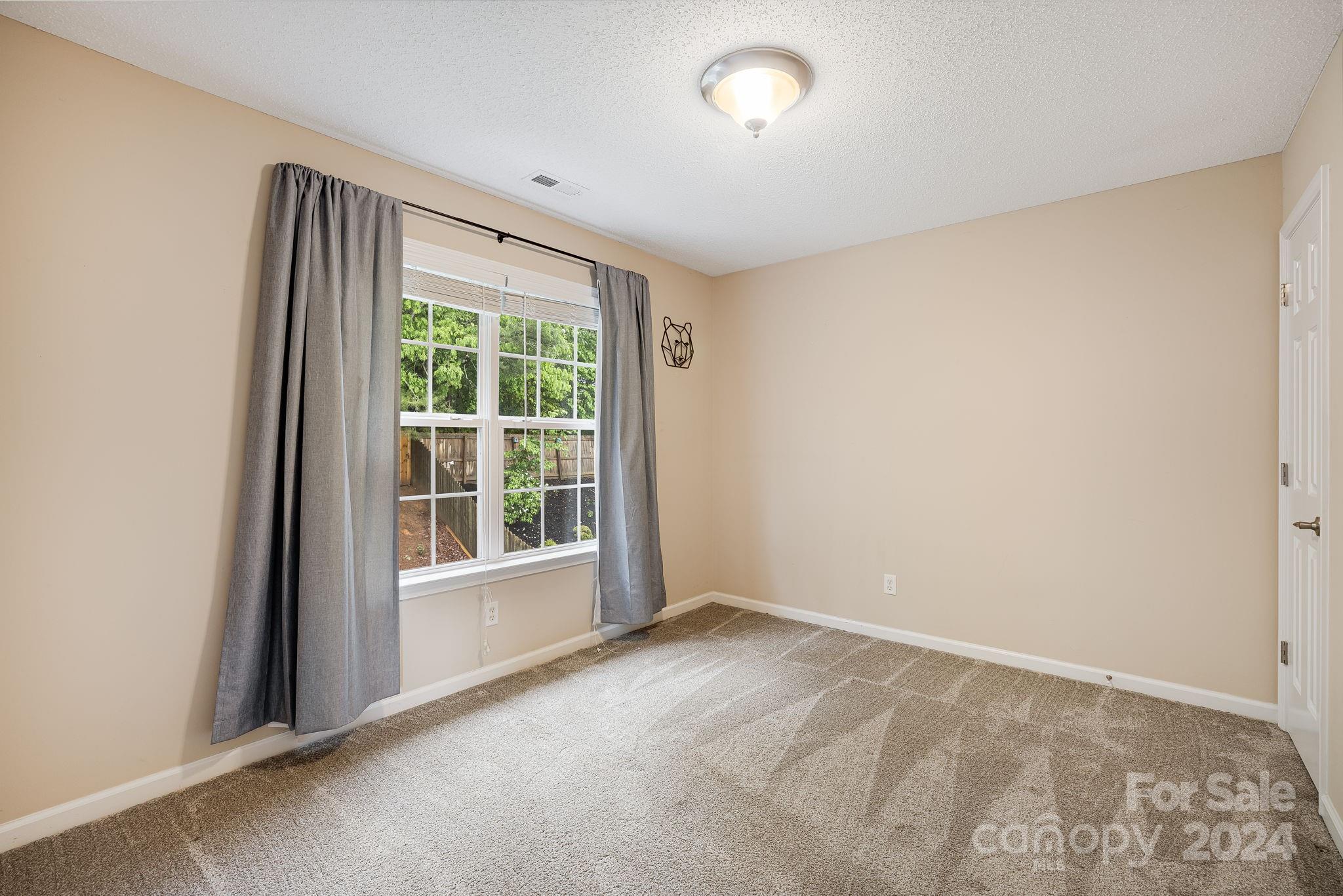 59 Yadkin Road Fletcher, NC 28732 - Photo 18 of 35 a view of an empty room with a window