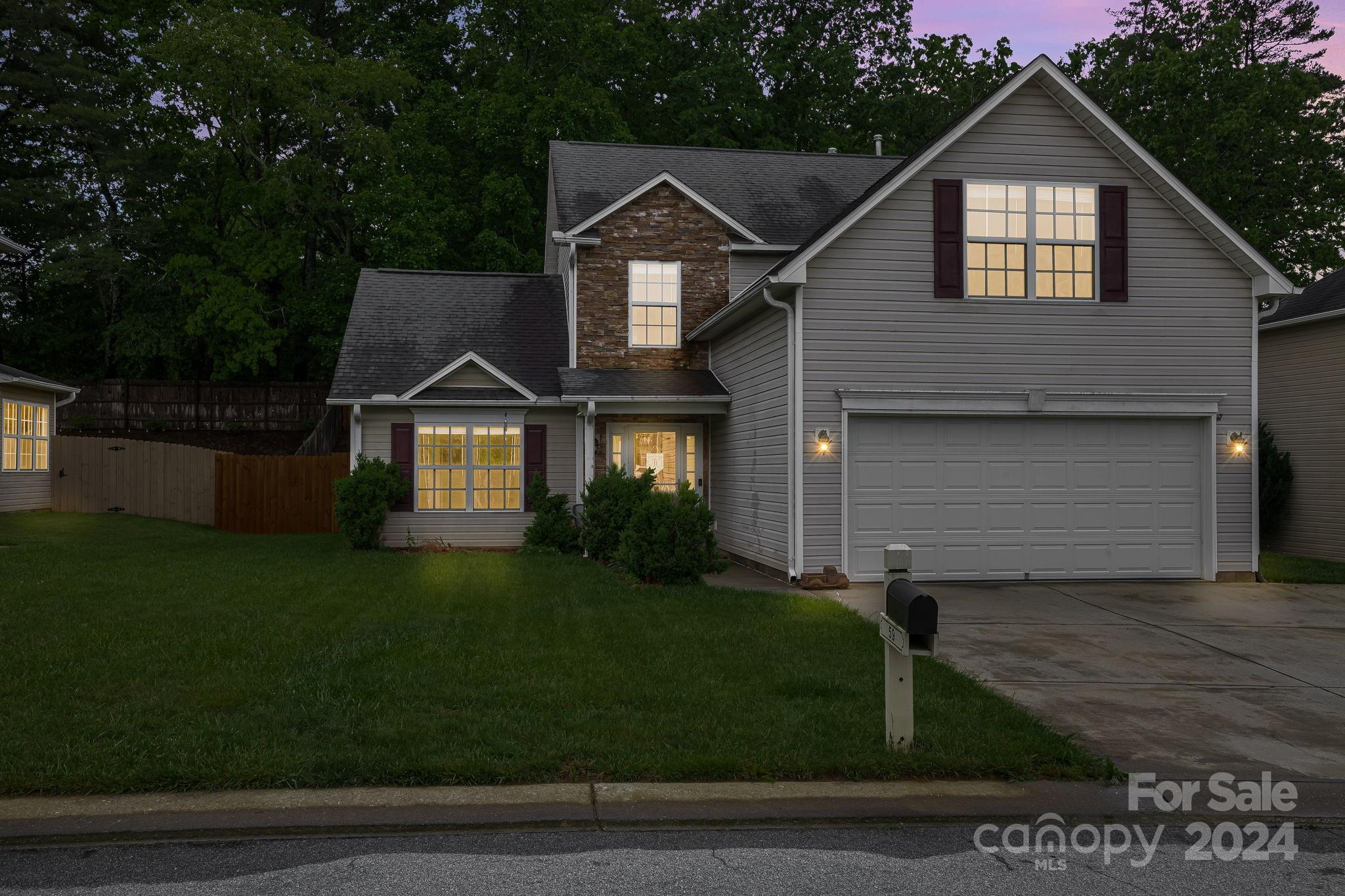 59 Yadkin Road Fletcher, NC 28732 - Photo 2 of 35 a front view of a house with a yard and garage