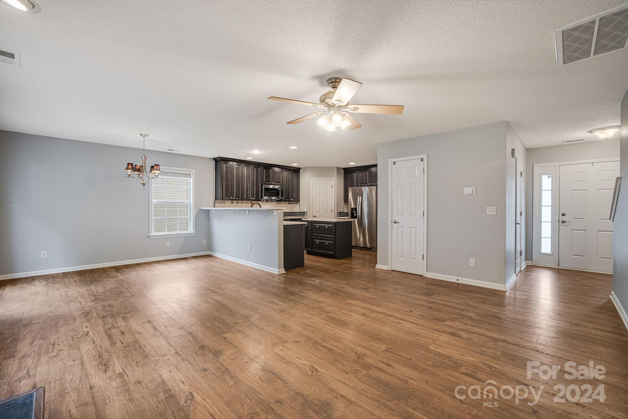 59 Yadkin Road Fletcher, NC 28732 - Photo 6 of 35 a view of a kitchen with a sink a microwave and a refrigerator