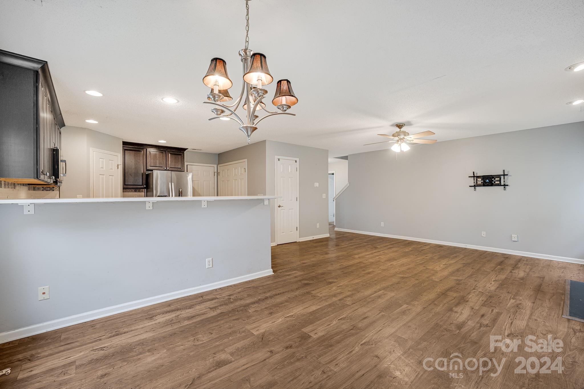 59 Yadkin Road Fletcher, NC 28732 - Photo 8 of 35 an empty room with wooden floor and windows