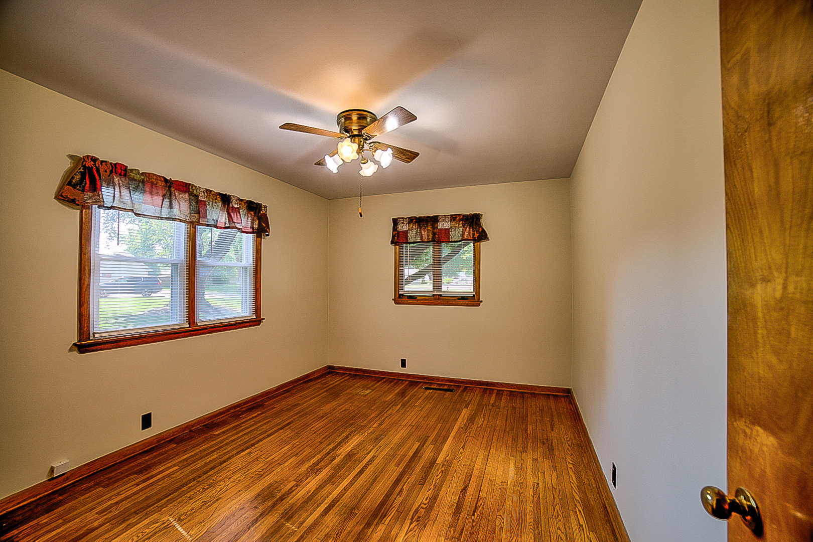 912 East Locust Street Watseka, IL 60970 - Photo 14 of 18 a view of an empty room with window and wooden floor