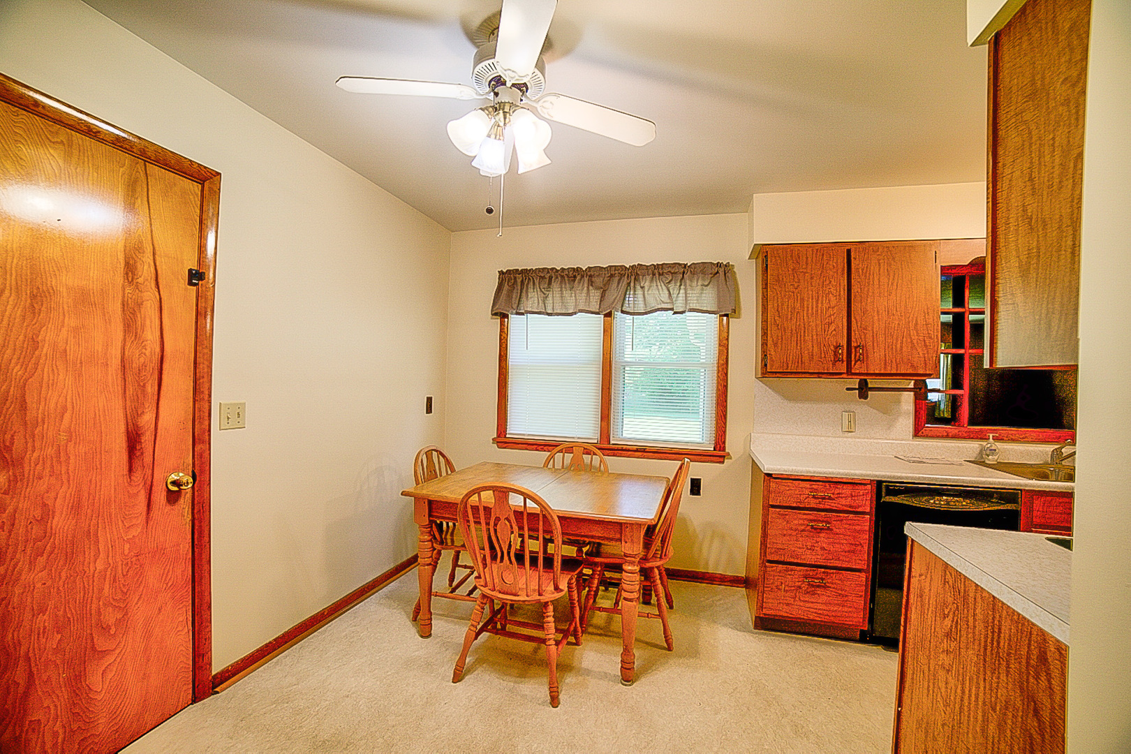 912 East Locust Street Watseka, IL 60970 - Photo 5 of 18 a kitchen with stainless steel appliances a table and chairs in it