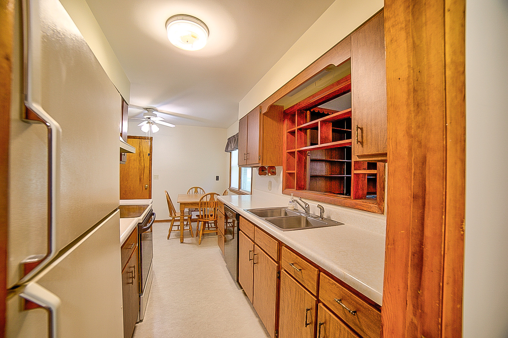 912 East Locust Street Watseka, IL 60970 - Photo 7 of 18 a kitchen with granite countertop a sink and a stove top oven