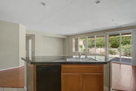 a kitchen with granite countertop a sink and a window
