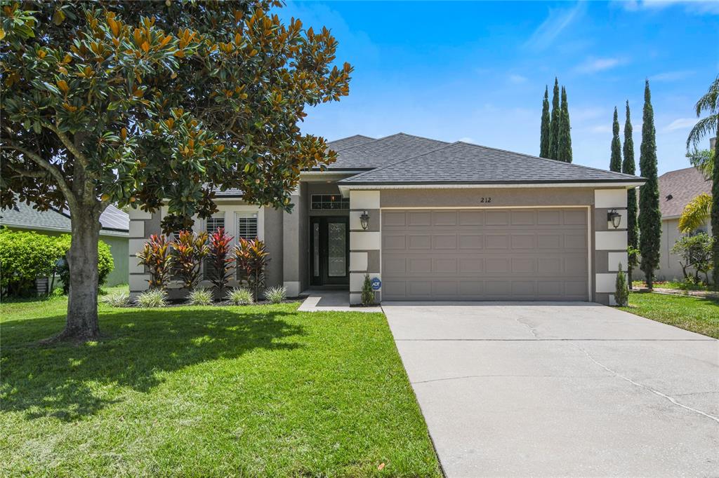 a front view of a house with a yard and garage
