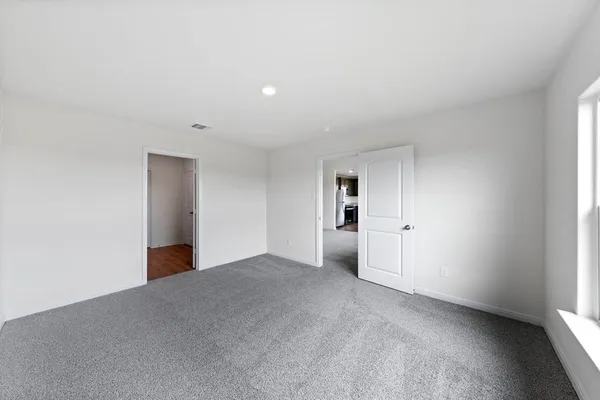 a view of empty room with a fireplace