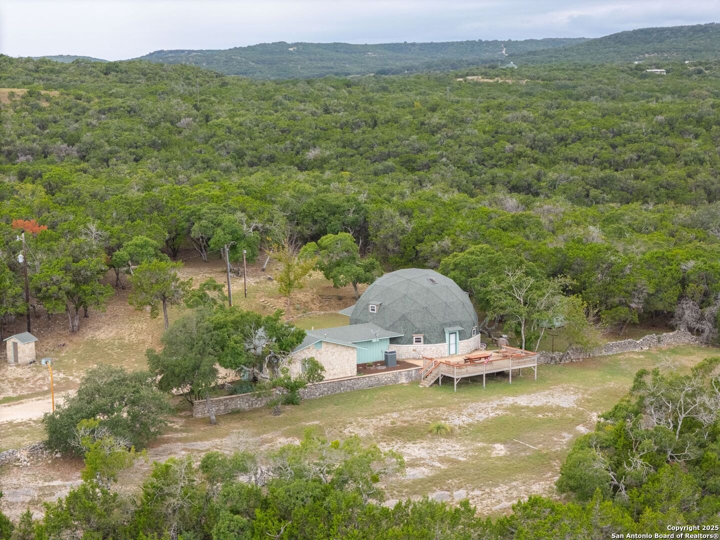 448 Red Rock Road Blanco, TX 78606 - Photo 24 of 52 a view of a lake with a mountain in the background