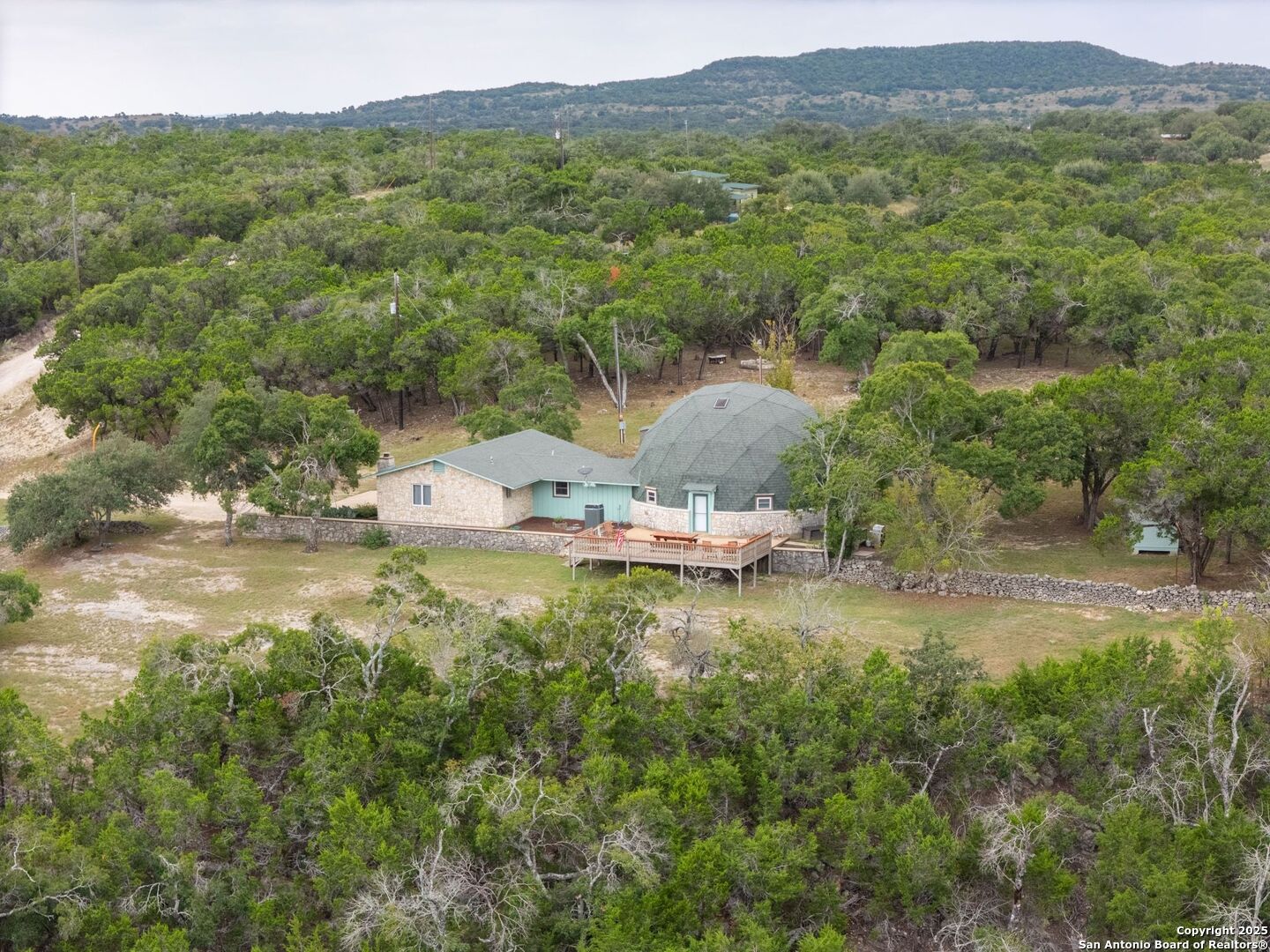 448 Red Rock Road Blanco, TX 78606 - Photo 28 of 52 an aerial view of residential houses with outdoor space and trees
