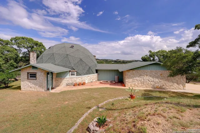 a aerial view of a house with a yard and lake view