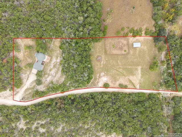 a view of large tree with wooden fence