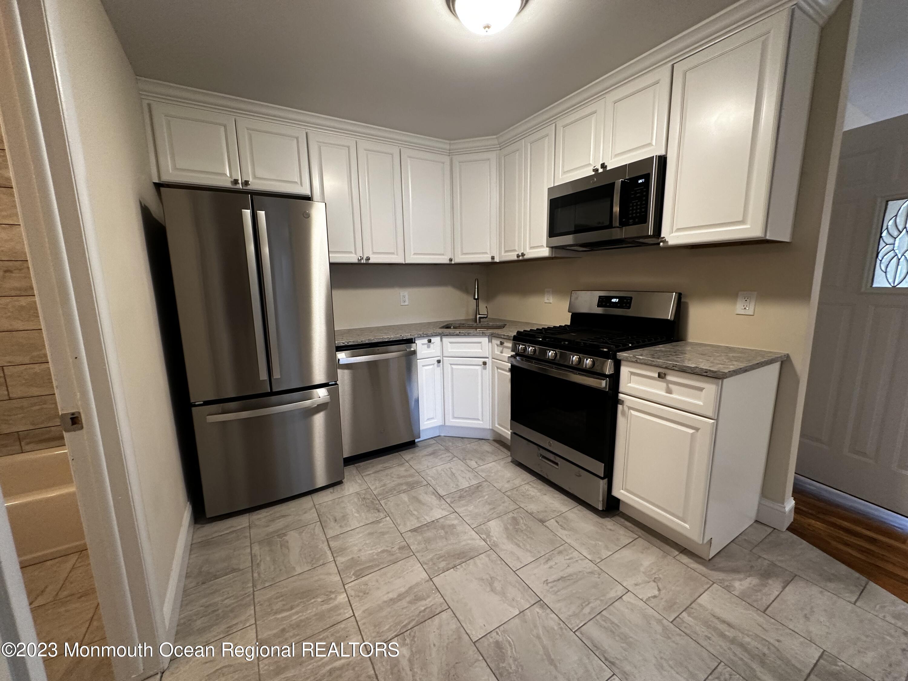a kitchen with a refrigerator stove and microwave
