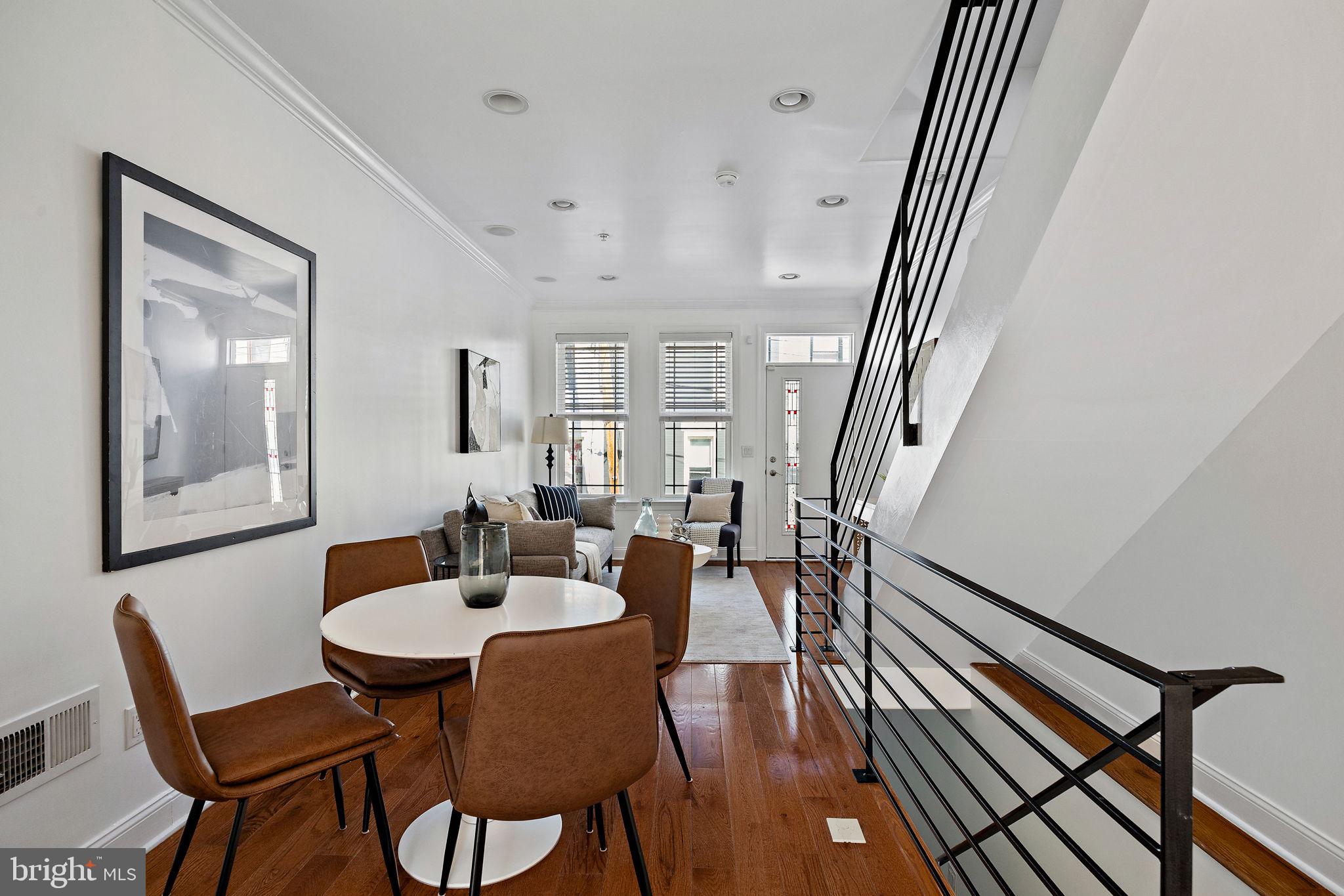 a view of a dining room with furniture and wooden floor