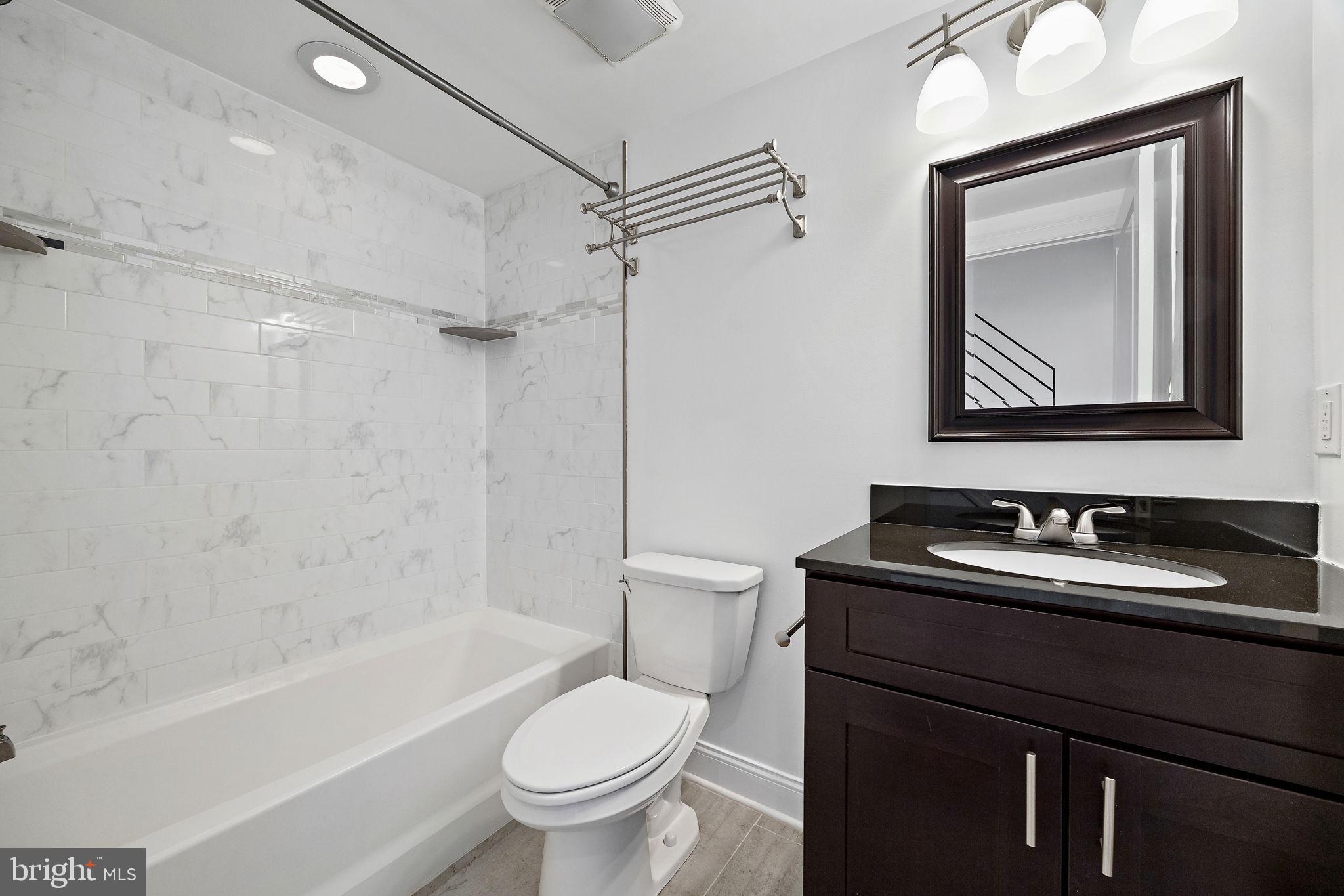 432 Mercy Street Philadelphia, PA 19148 - Photo 17 of 36 a bathroom with a toilet sink vanity tub and shower