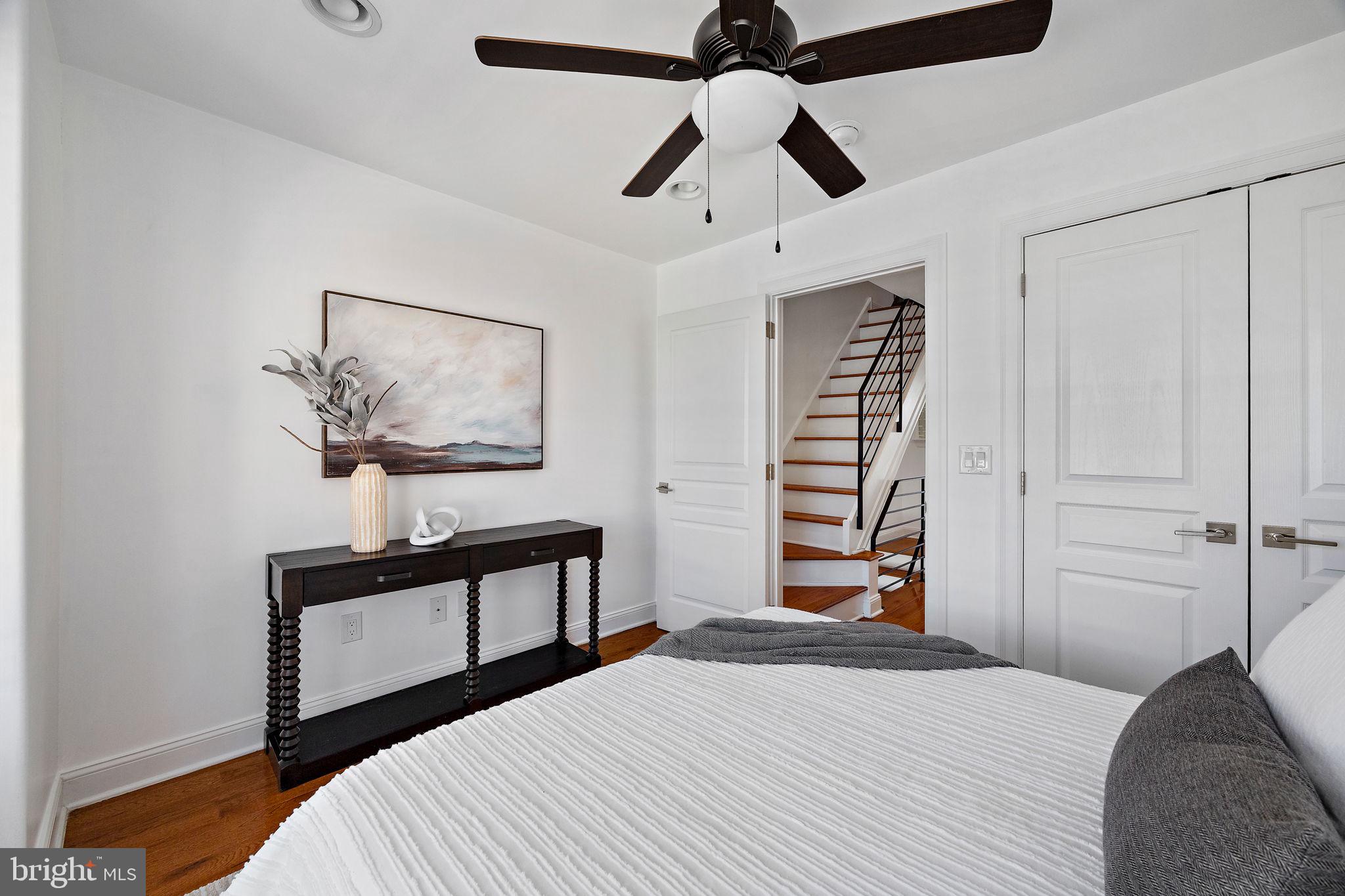 432 Mercy Street Philadelphia, PA 19148 - Photo 20 of 36 a bedroom with a bed and a chandelier