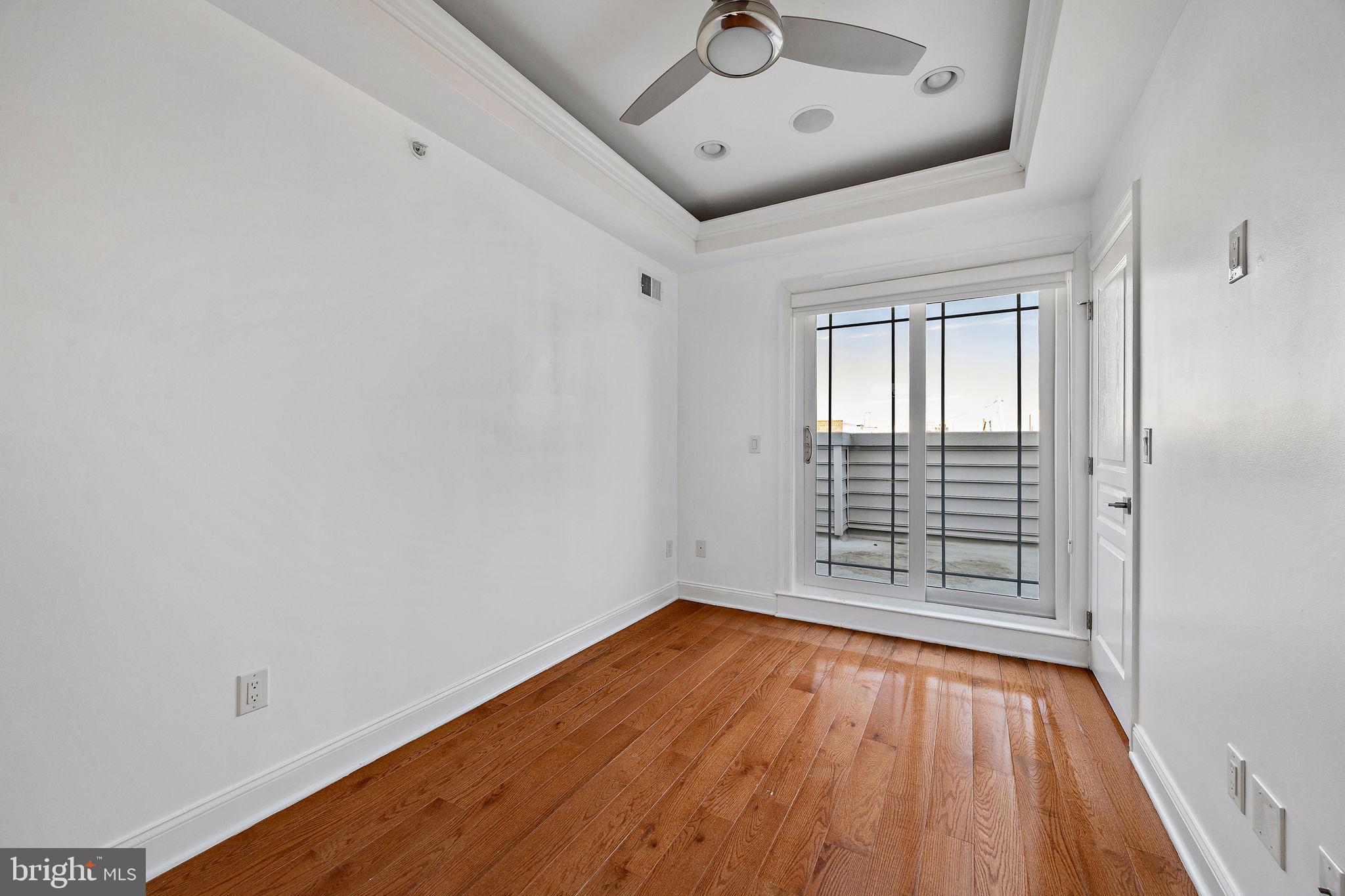 432 Mercy Street Philadelphia, PA 19148 - Photo 22 of 36 a view of an empty room with wooden floor and a window