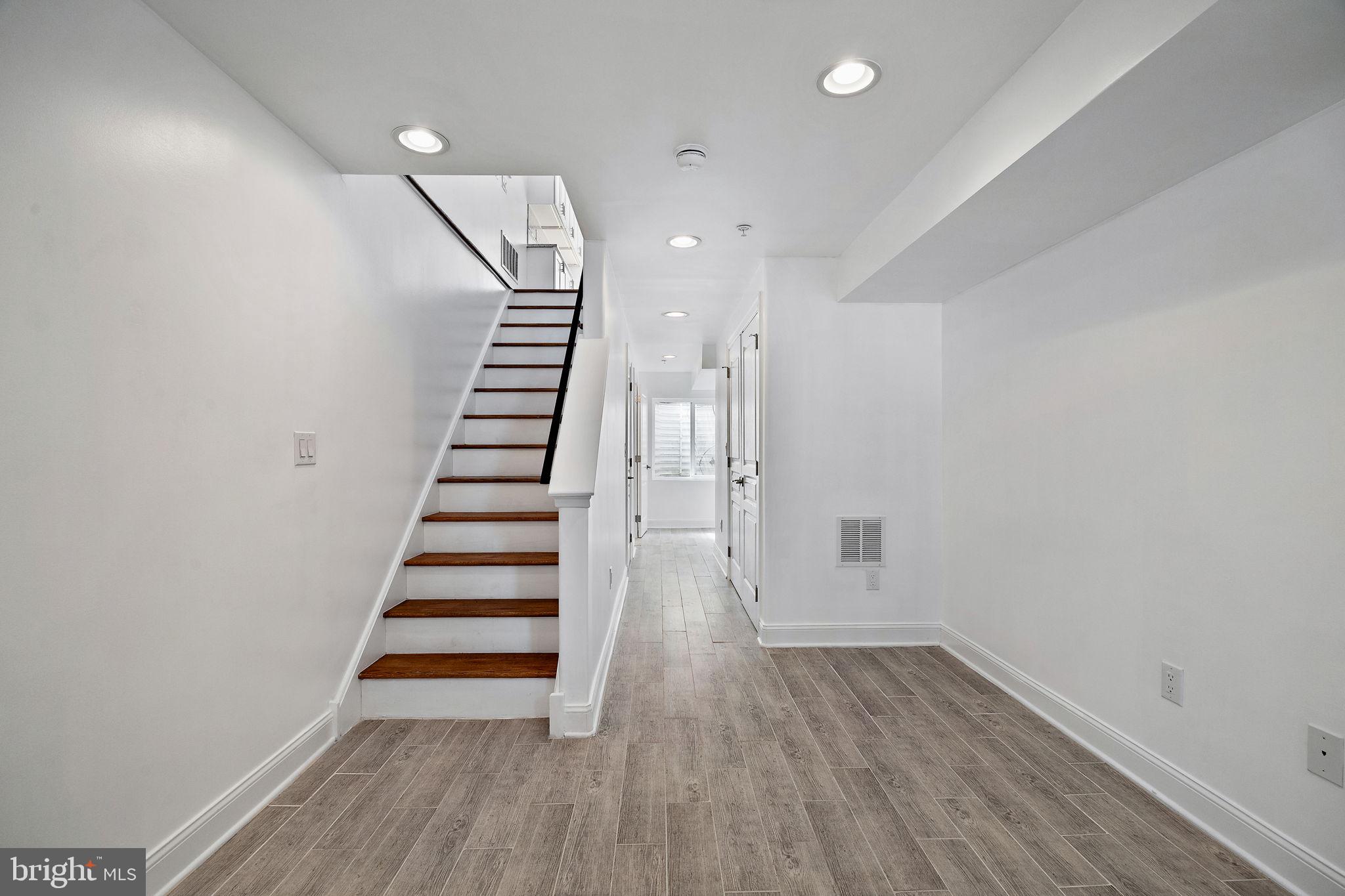432 Mercy Street Philadelphia, PA 19148 - Photo 33 of 36 a view of a room with wooden floors and stairs