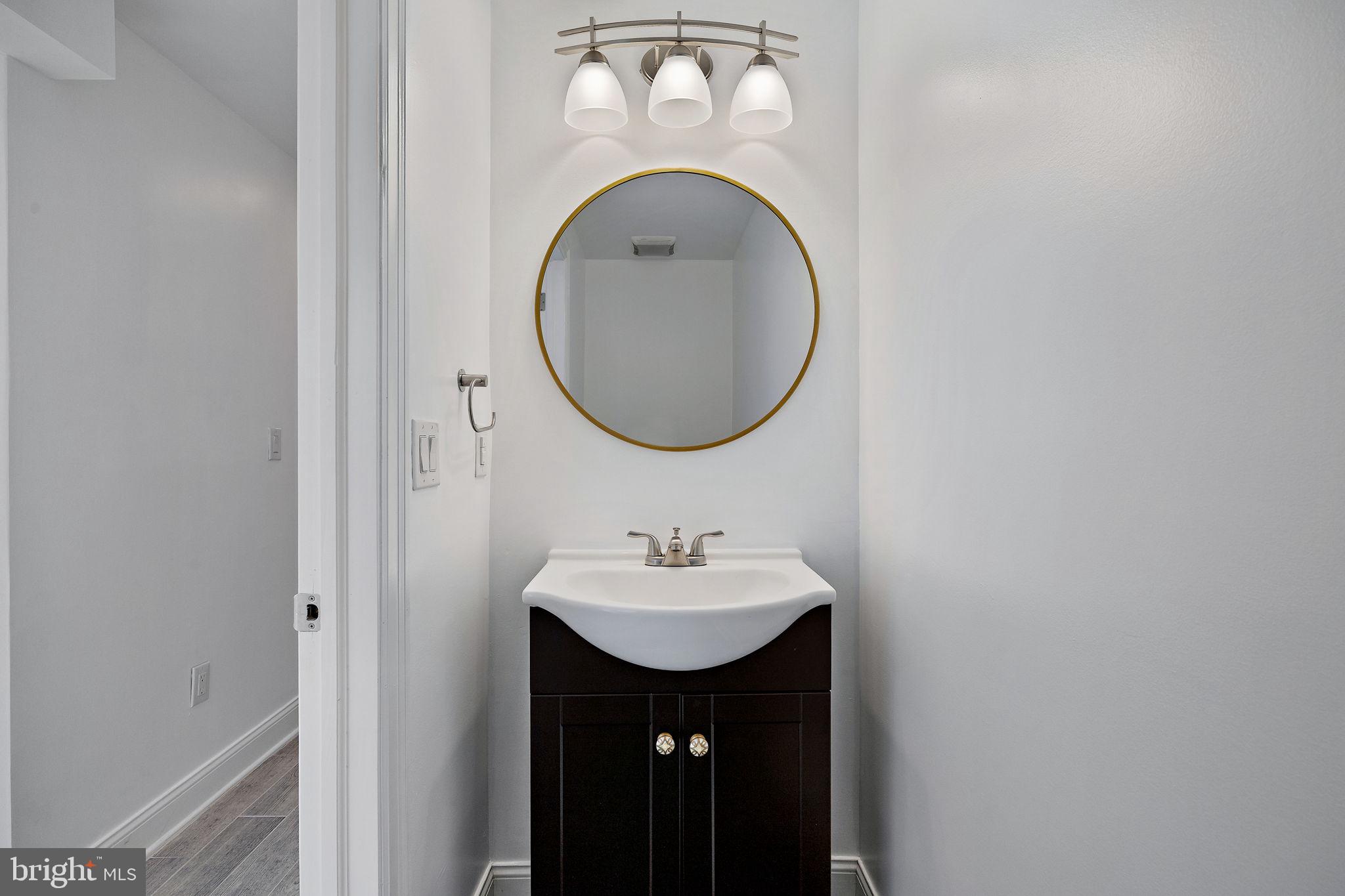 432 Mercy Street Philadelphia, PA 19148 - Photo 36 of 36 a bathroom with a sink and a mirror