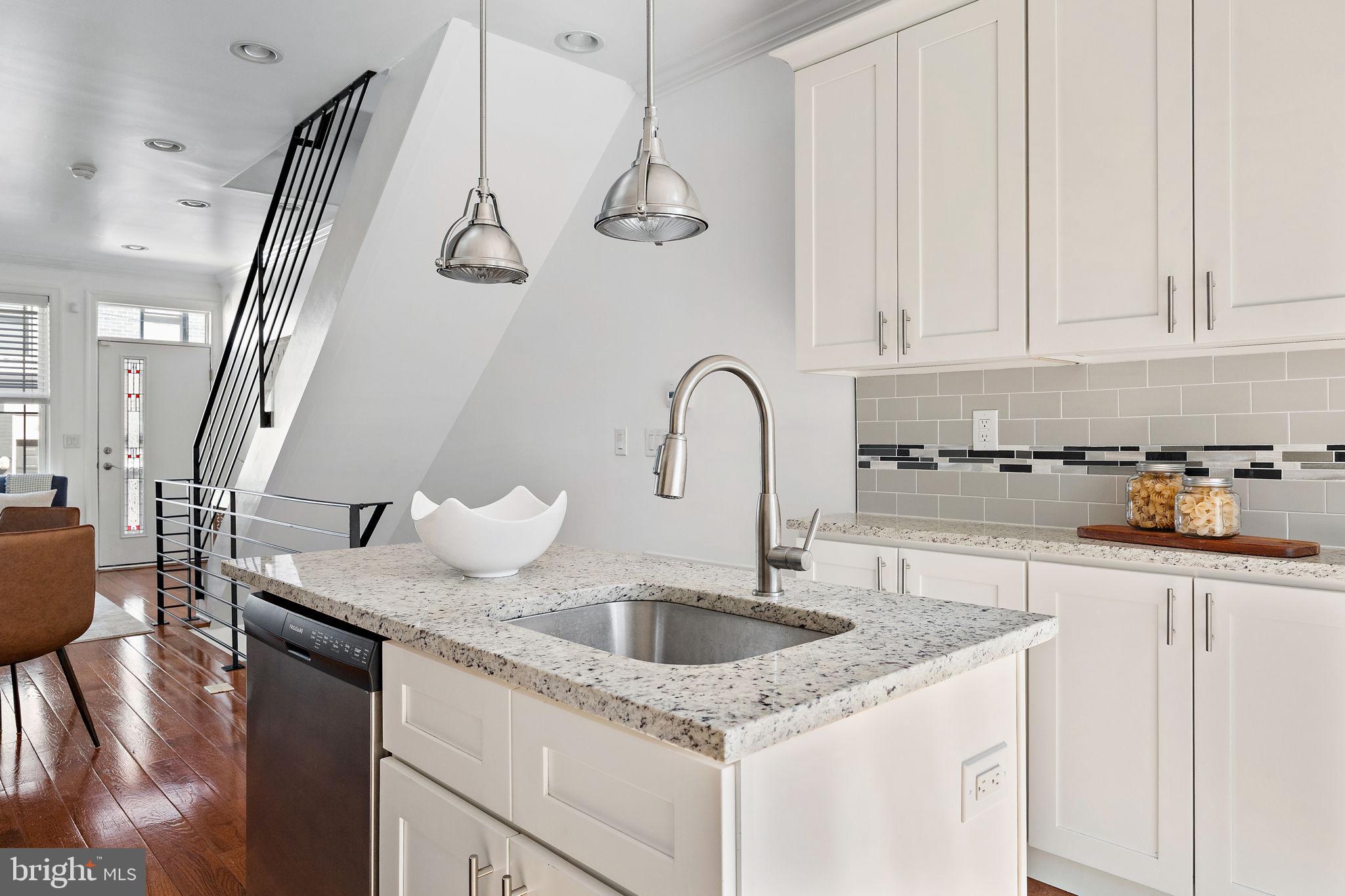 432 Mercy Street Philadelphia, PA 19148 - Photo 10 of 36 a kitchen with stainless steel appliances granite countertop a sink dishwasher and cabinets with wooden floor