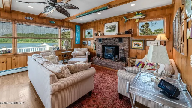 a living room with furniture fireplace and a large window