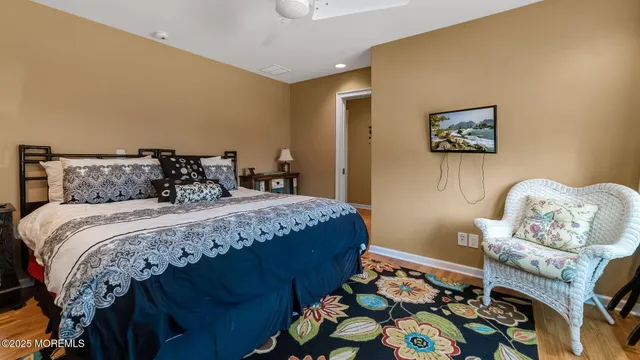 a bedroom with a bed and painting on the wall