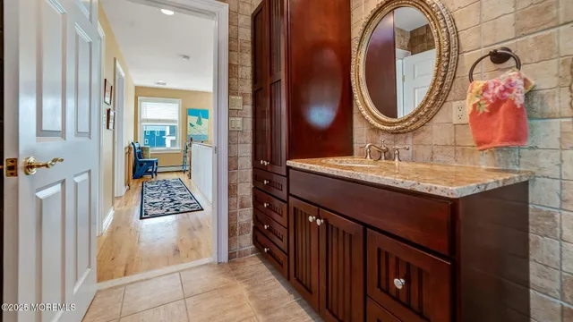 a bathroom with a sink vanity and a mirror