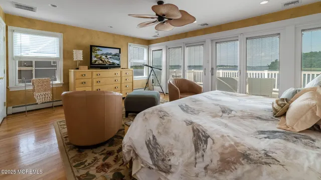 a bedroom with two beds and a flat screen tv