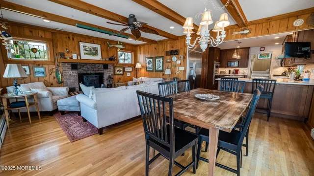 a view of a dining room with furniture a chandelier and wooden floor