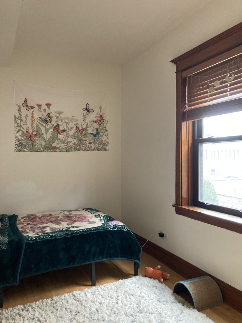 2223 West Iowa Street, Unit 2R Chicago, IL 60622 - Photo 13 of 20 a bedroom with a bed and window