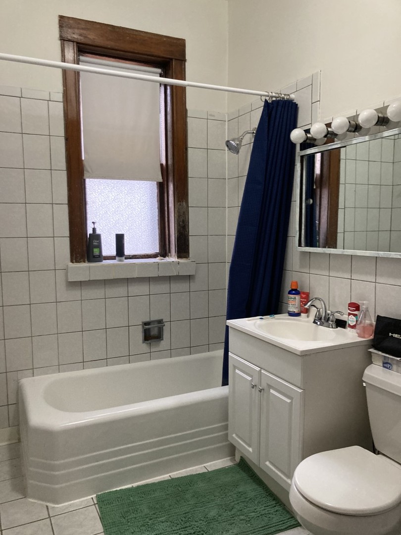 2223 West Iowa Street, Unit 2R Chicago, IL 60622 - Photo 16 of 20 a bathroom with a sink a toilet and shower