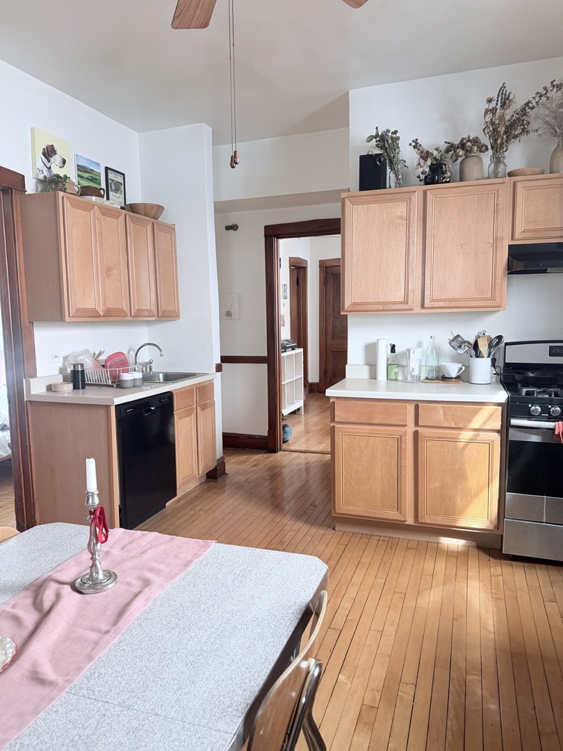 2223 West Iowa Street, Unit 2R Chicago, IL 60622 - Photo 10 of 20 a kitchen with a stove a sink and a refrigerator