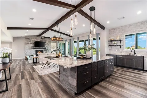 a large room with lots of counter space and windows