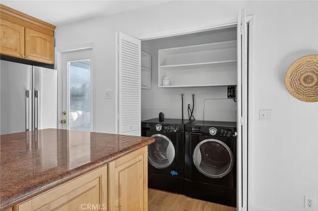a utility room with closet dryer and washer