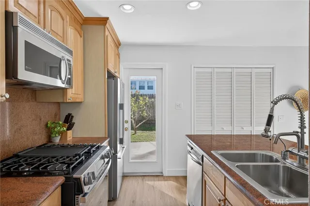 a kitchen that has a sink and a stove
