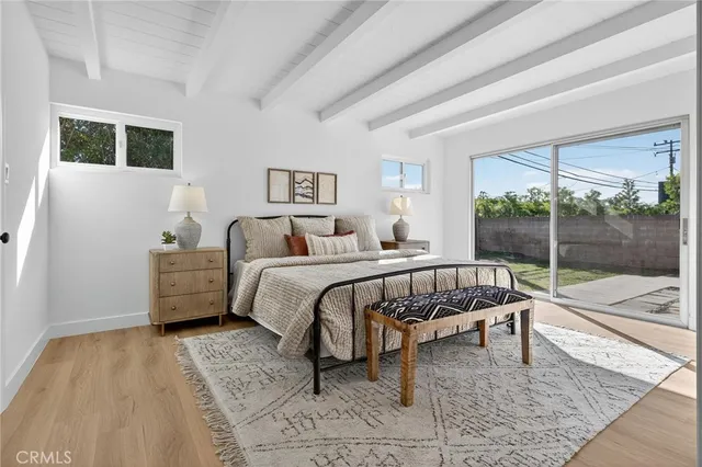 a bedroom with a bed and large window