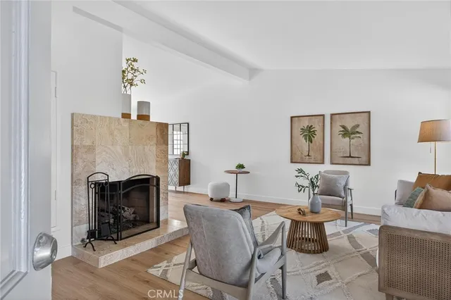 a living room with furniture a fireplace and a table
