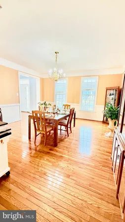 a view of a dining room with furniture and a potted plant