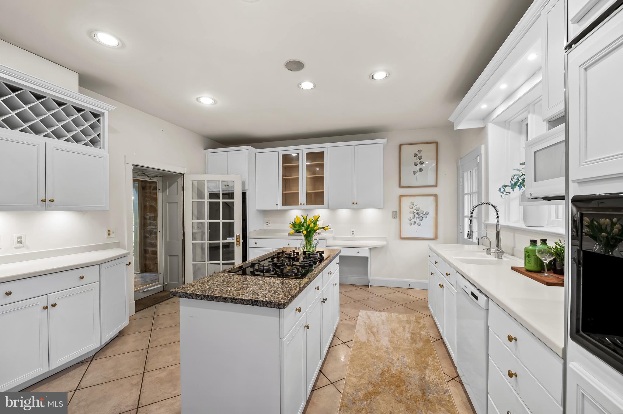116 Enfield Road Baltimore, MD 21212 - Photo 17 of 71 a large white kitchen with stainless steel appliances granite countertop a stove and a sink