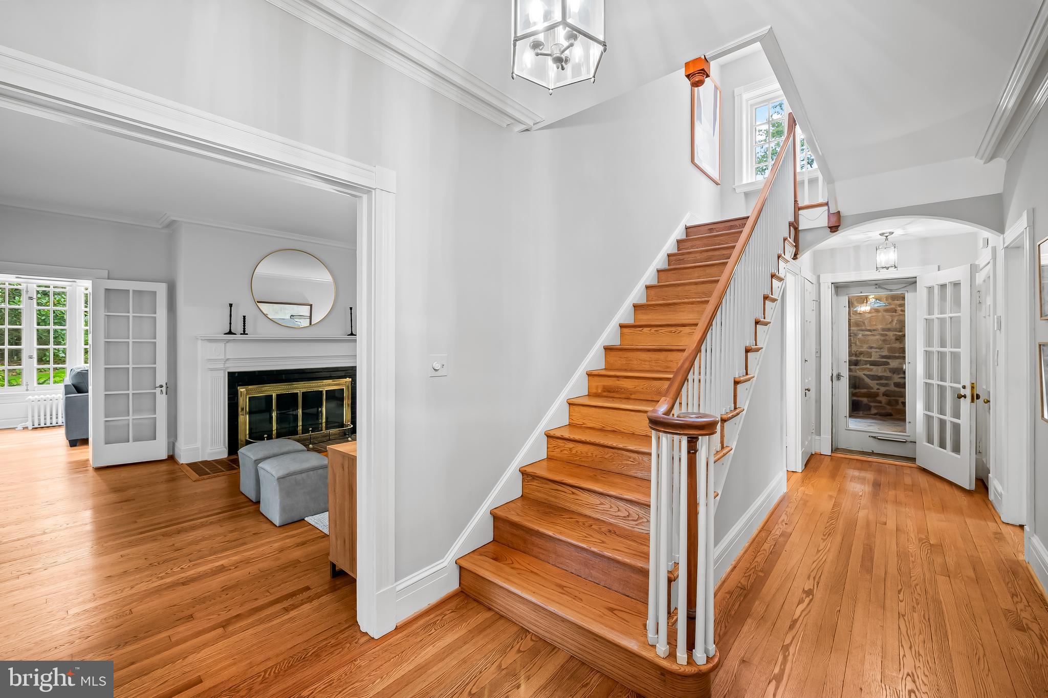 116 Enfield Road Baltimore, MD 21212 - Photo 4 of 71 a view of a hallway with wooden floor fireplace and a chandelier
