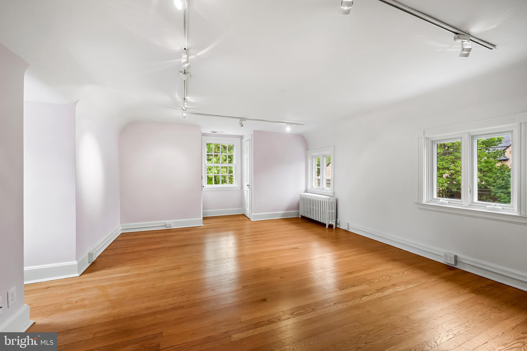 116 Enfield Road Baltimore, MD 21212 - Photo 42 of 71 an empty room with wooden floor and windows