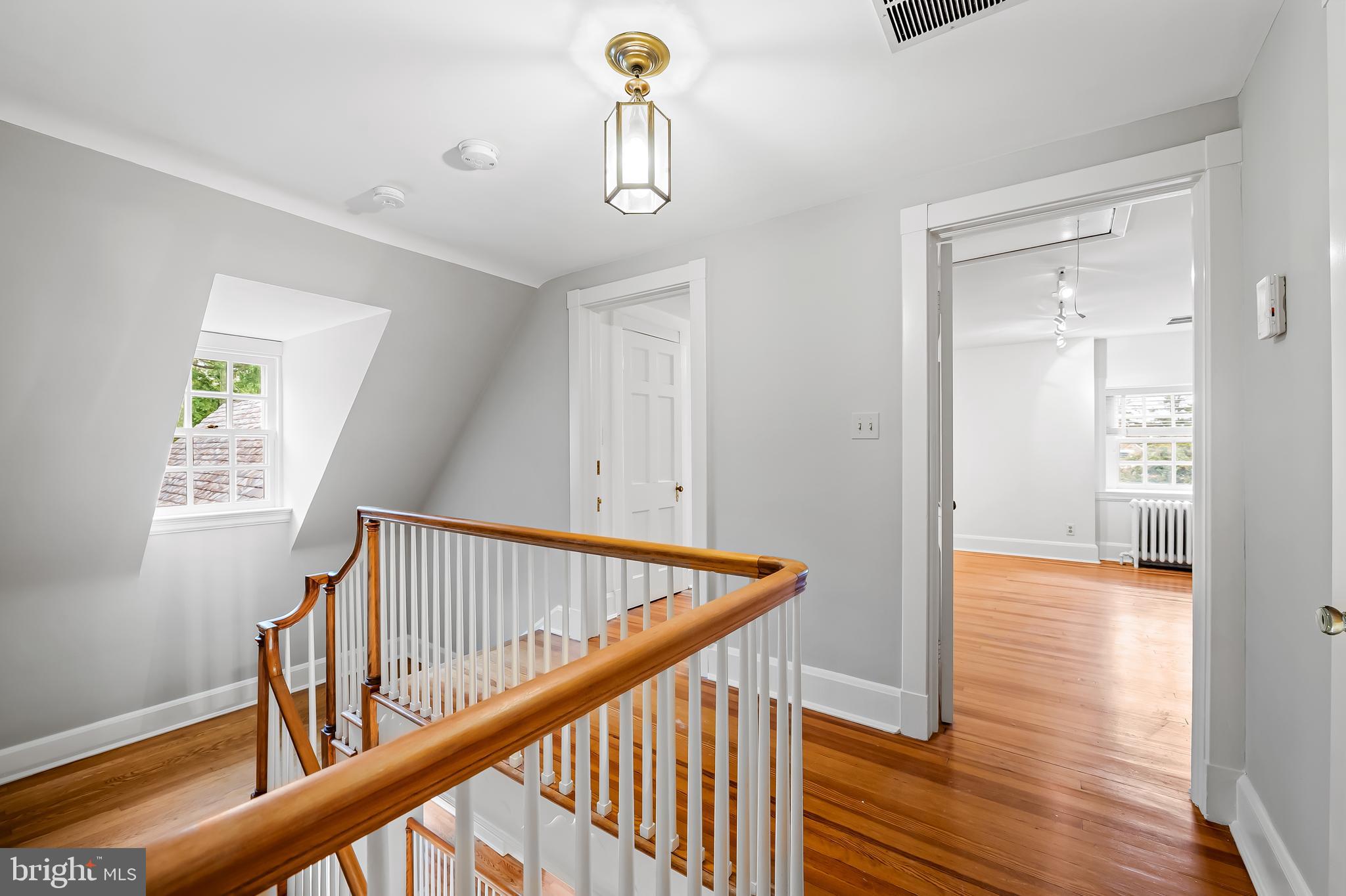 116 Enfield Road Baltimore, MD 21212 - Photo 43 of 71 a view of a hallway with wooden floor and stairs