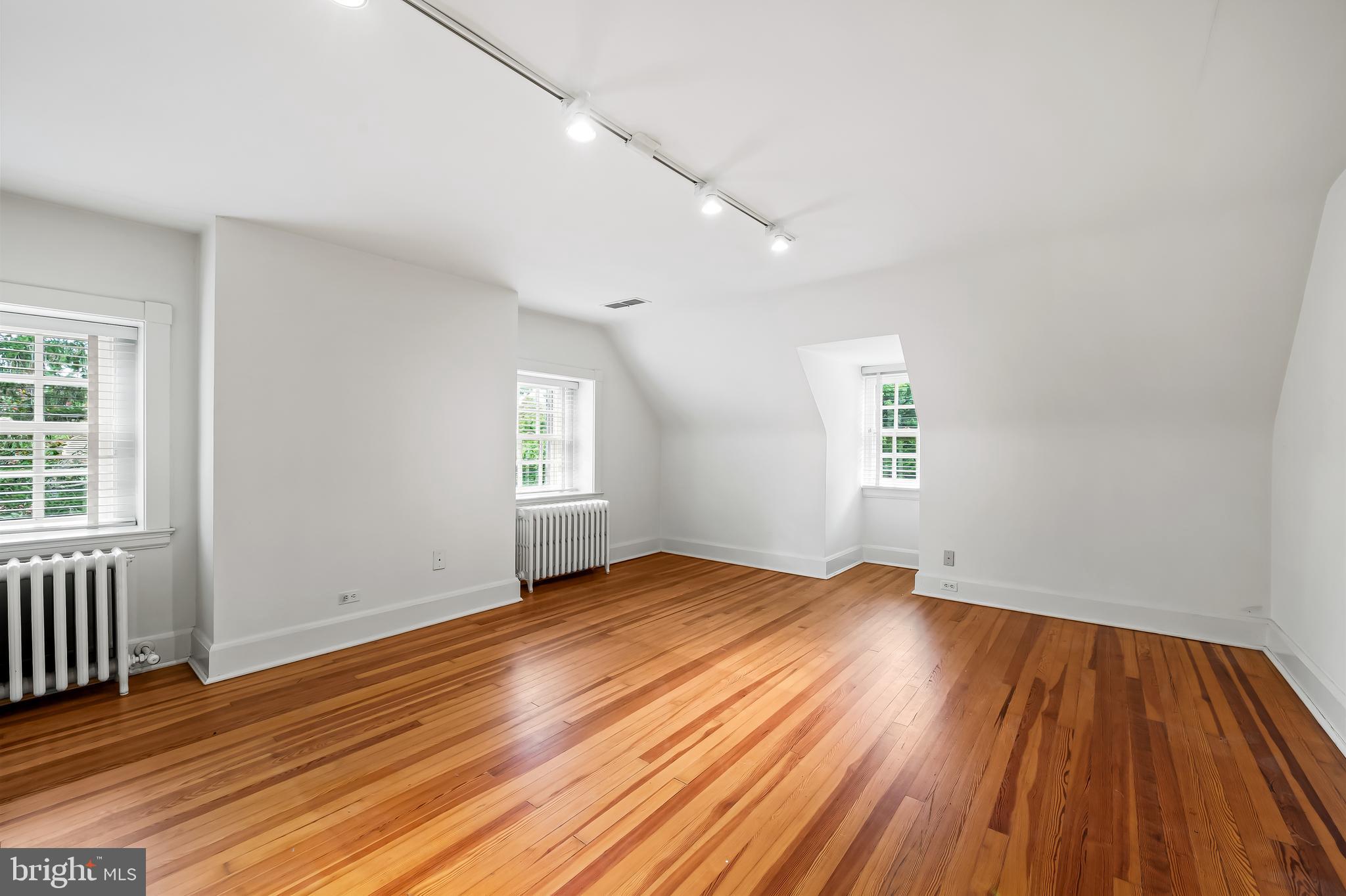 116 Enfield Road Baltimore, MD 21212 - Photo 44 of 71 an empty room with wooden floor and windows