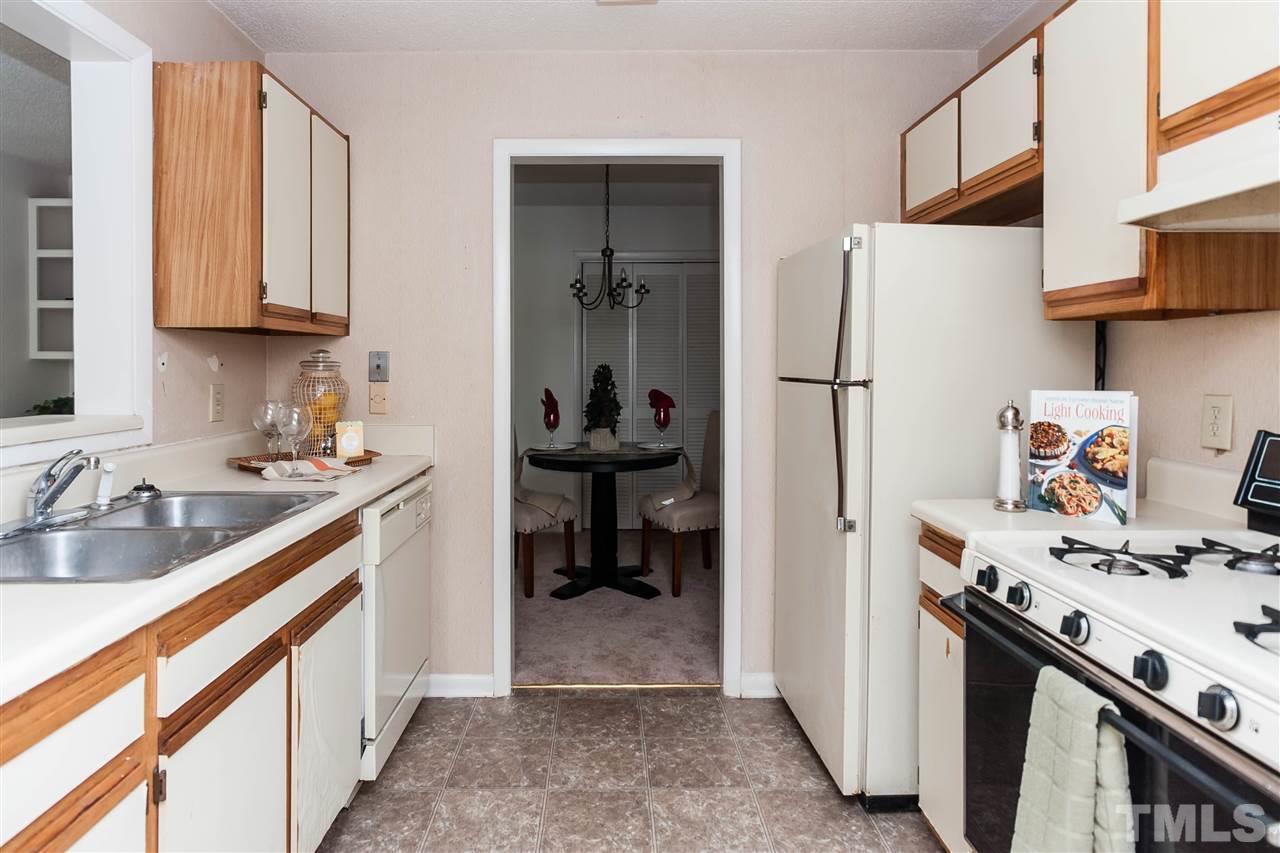 5808 Pointer Drive Raleigh, NC 27609 - Photo 10 of 19 a kitchen with a sink cabinets and a refrigerator