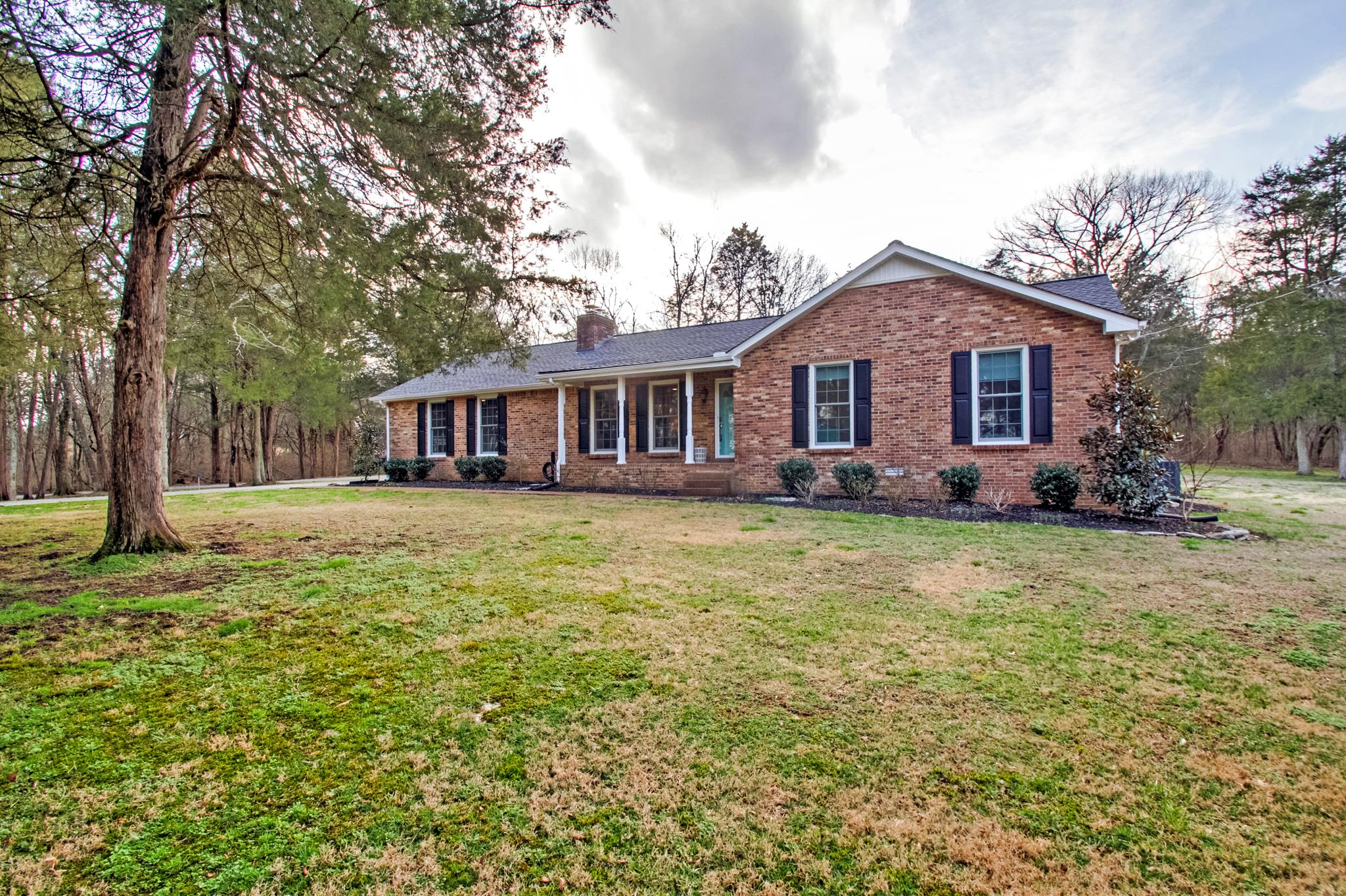 3637 North Chapel Road Franklin, TN 37067 - Photo 1 of 30 a front view of a house with a garden and trees