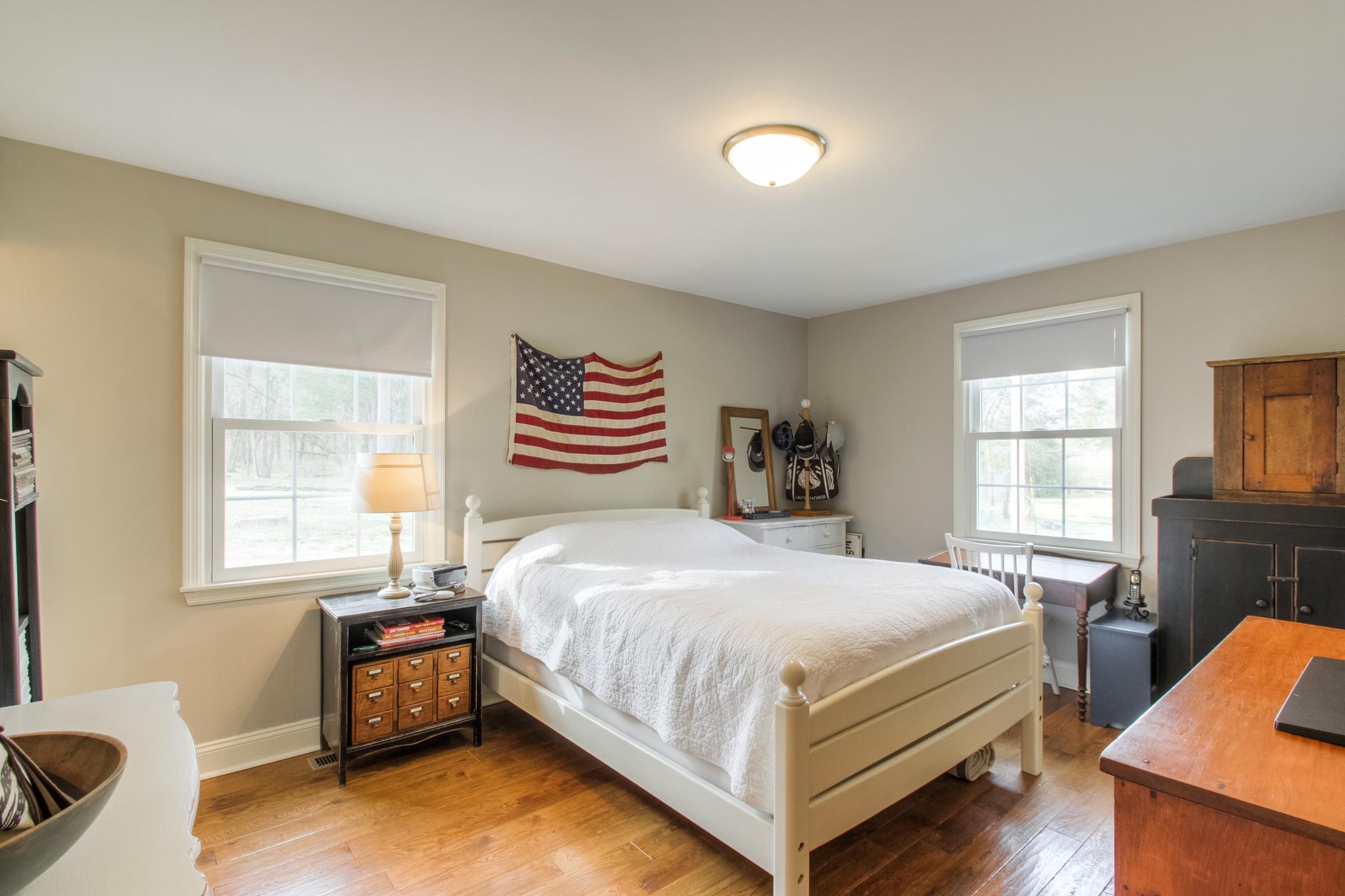 3637 North Chapel Road Franklin, TN 37067 - Photo 17 of 30 a bedroom with a bed and wooden floor