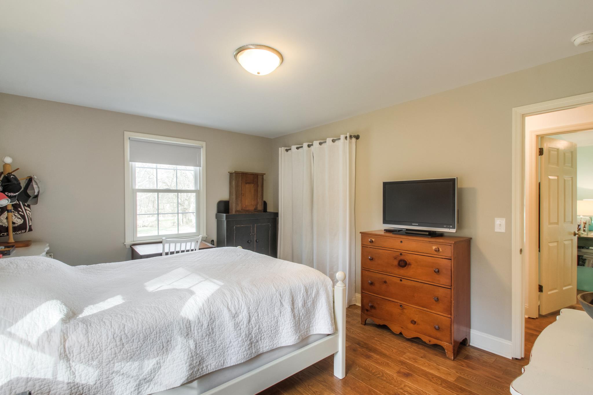 3637 North Chapel Road Franklin, TN 37067 - Photo 18 of 30 a bedroom with a bed and a flat screen tv