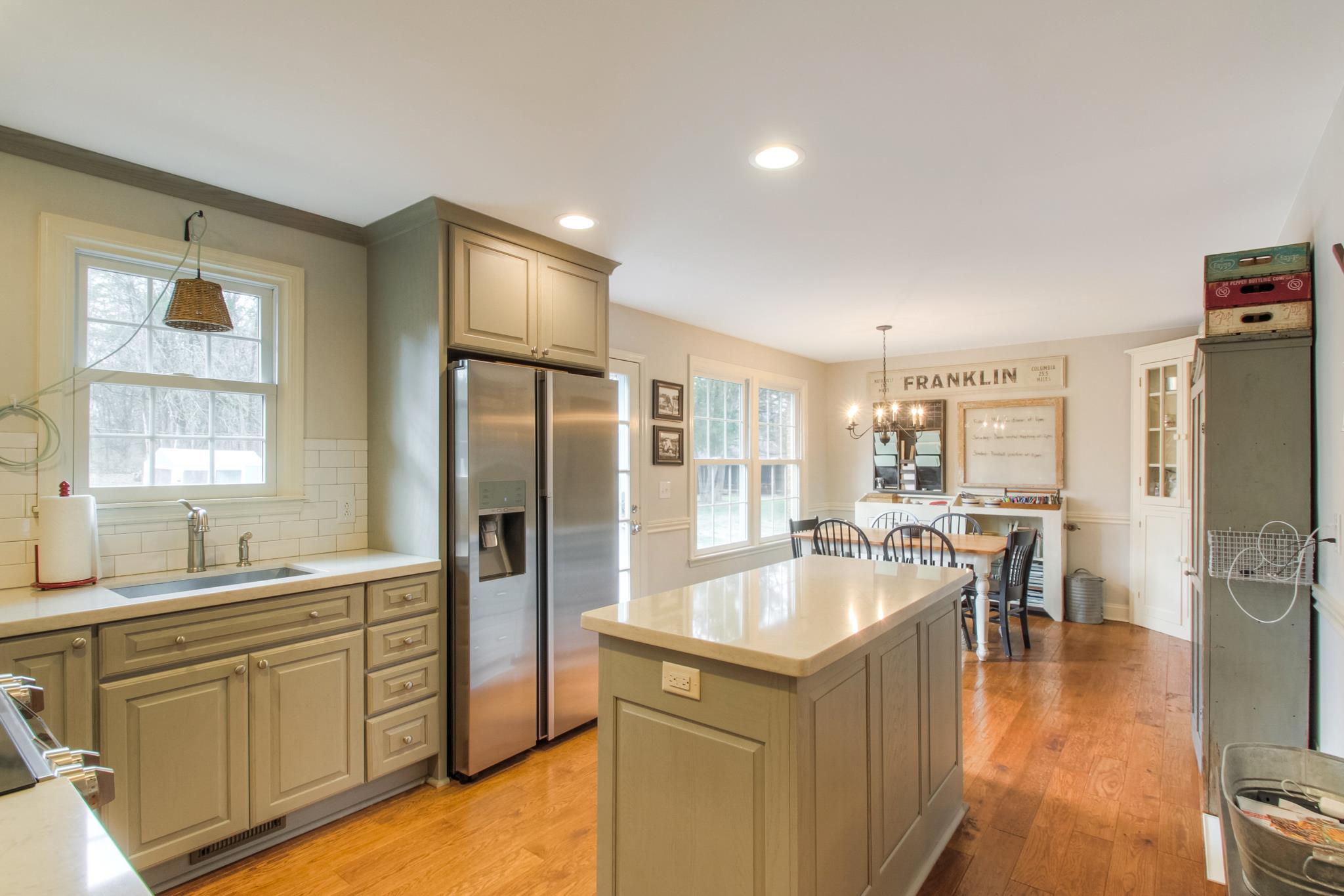 3637 North Chapel Road Franklin, TN 37067 - Photo 6 of 30 a large kitchen with kitchen island a large counter top space a sink stainless steel appliances and cabinets